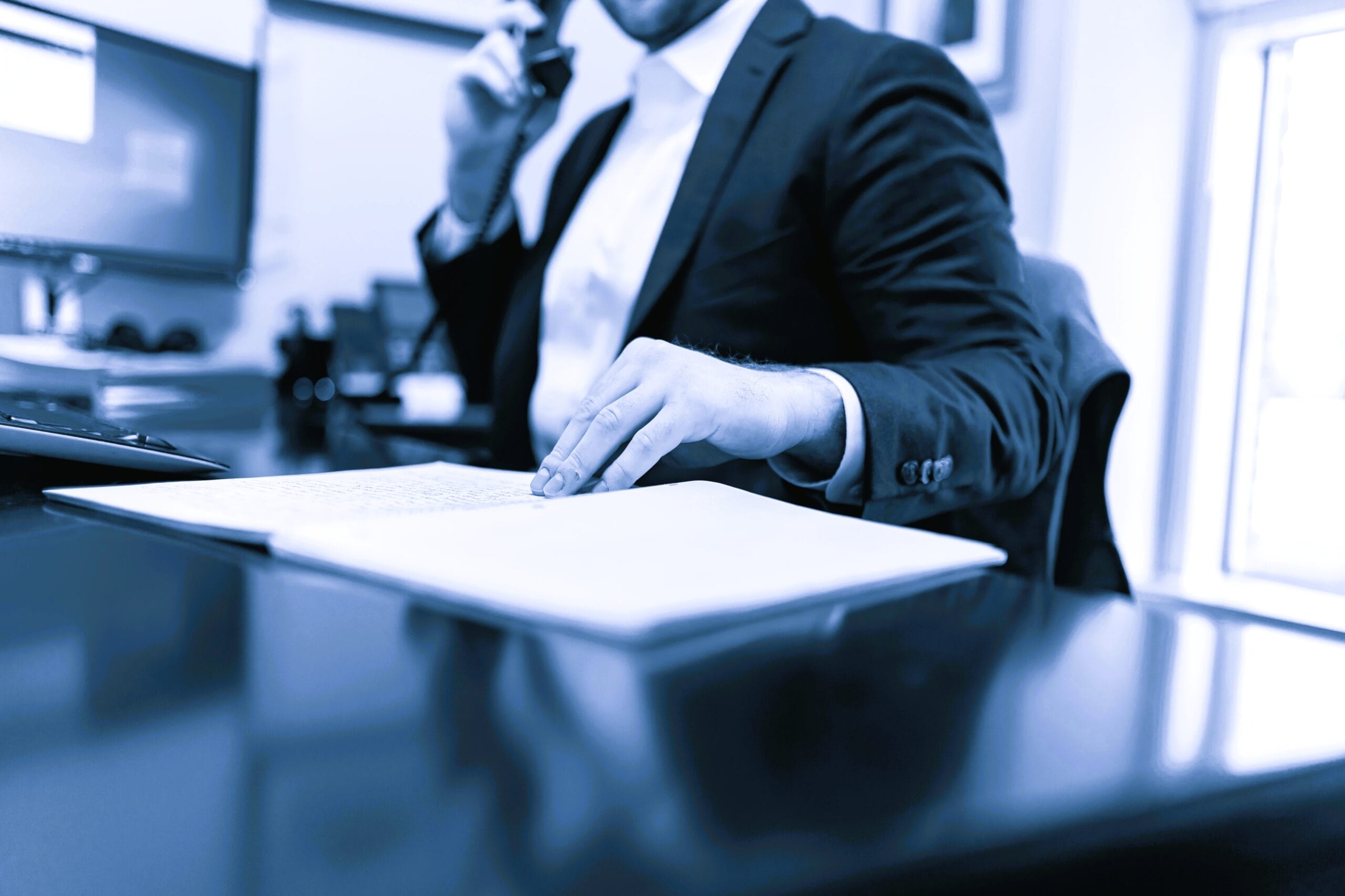 Boardroom executive reviewing WHS officer due diligence reports.